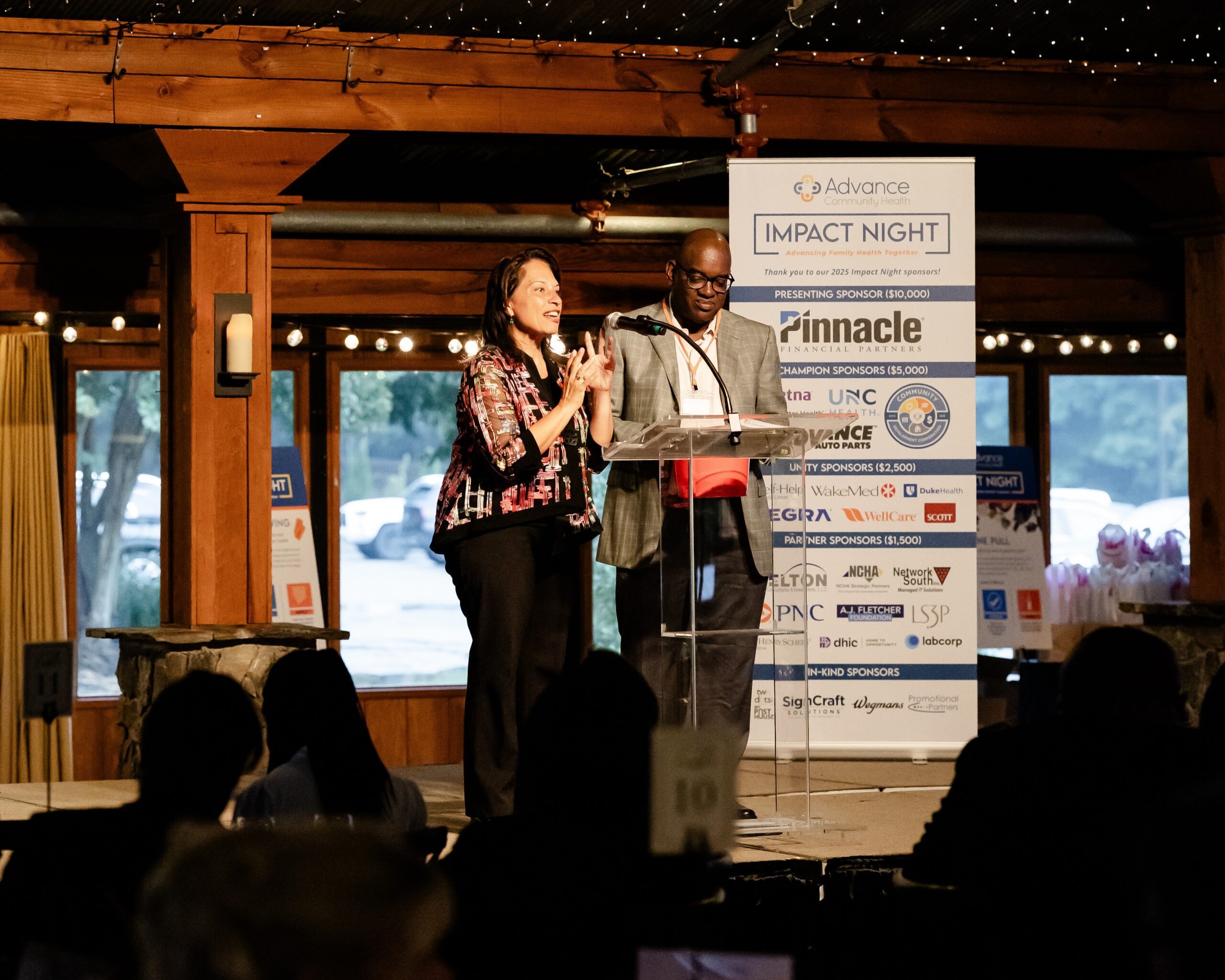 Two male pharmacists speaking with each other